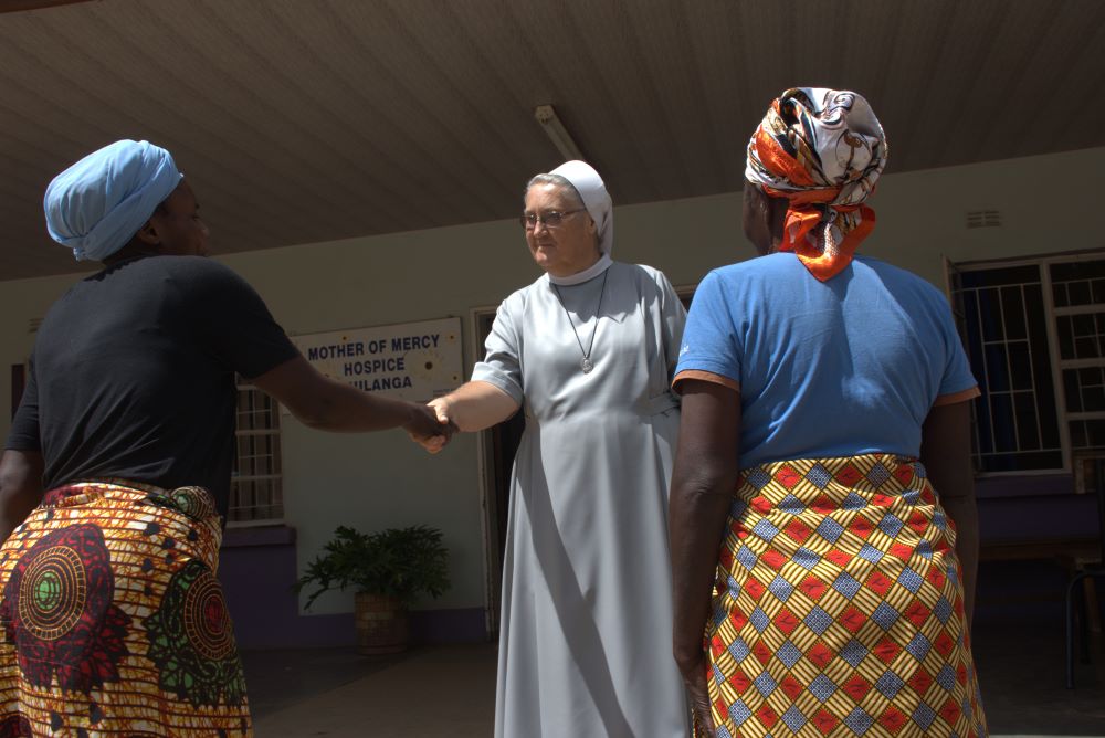Sr. Jeremia Mrowiec greets two women at hospice. Sr. Jeremia Mrowiec greets two women at hospice.