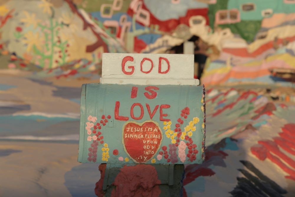 Artwork says "God is Love." Artwork says "God is Love."