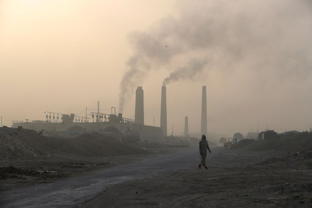 Smoke rises from brick factories' stacks in the town of Nahrawan in Baghdad, Iraq.