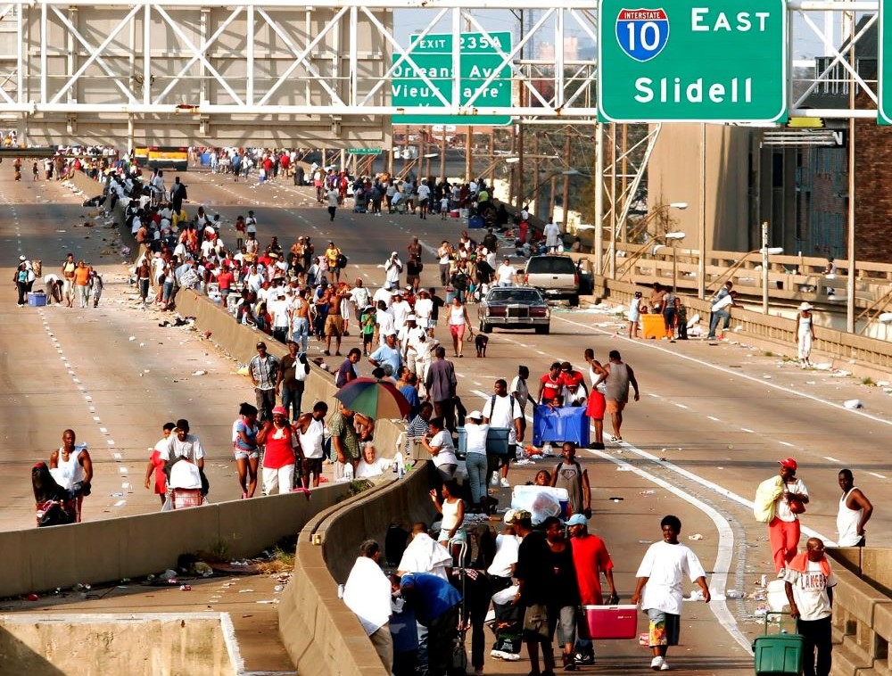 People walk on the elevated freeway in the aftermath of Hurricane Katrina in New Orleans Aug. 31, 2005.