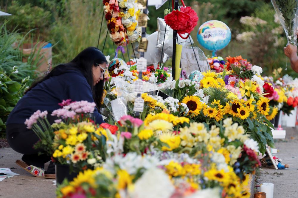 People leave flowers and keepsakes at a makeshift memorial at Annunciation Catholic Church. People leave flowers and keepsakes at a makeshift memorial at Annunciation Catholic Church.