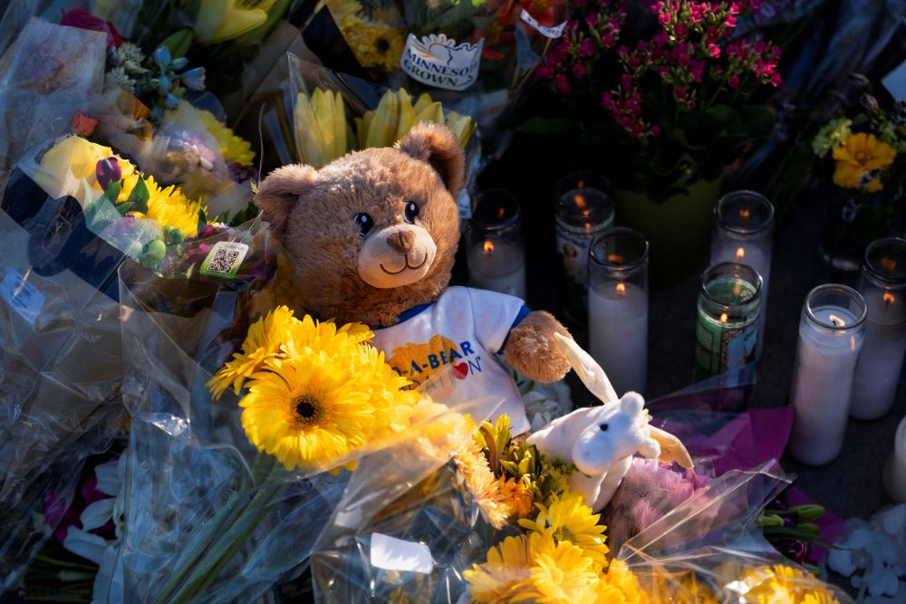 A teddy bear lies at a makeshift memorial at Annunciation Church