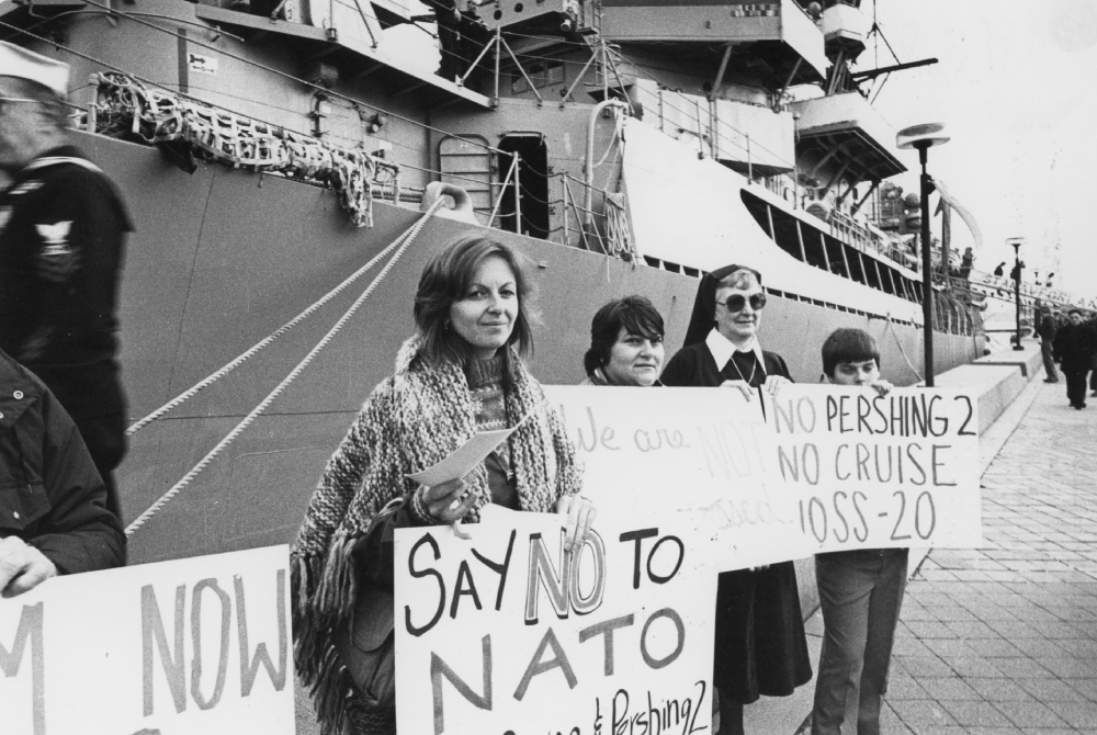 A vigil against nuclear weapons A sister in habit is seen among those holding a vigil against nuclear weapons on the pier alongside the guided-missile destroyer USS Dewey on Nov. 11, 1983. (NCR photo/Peter Wingert)