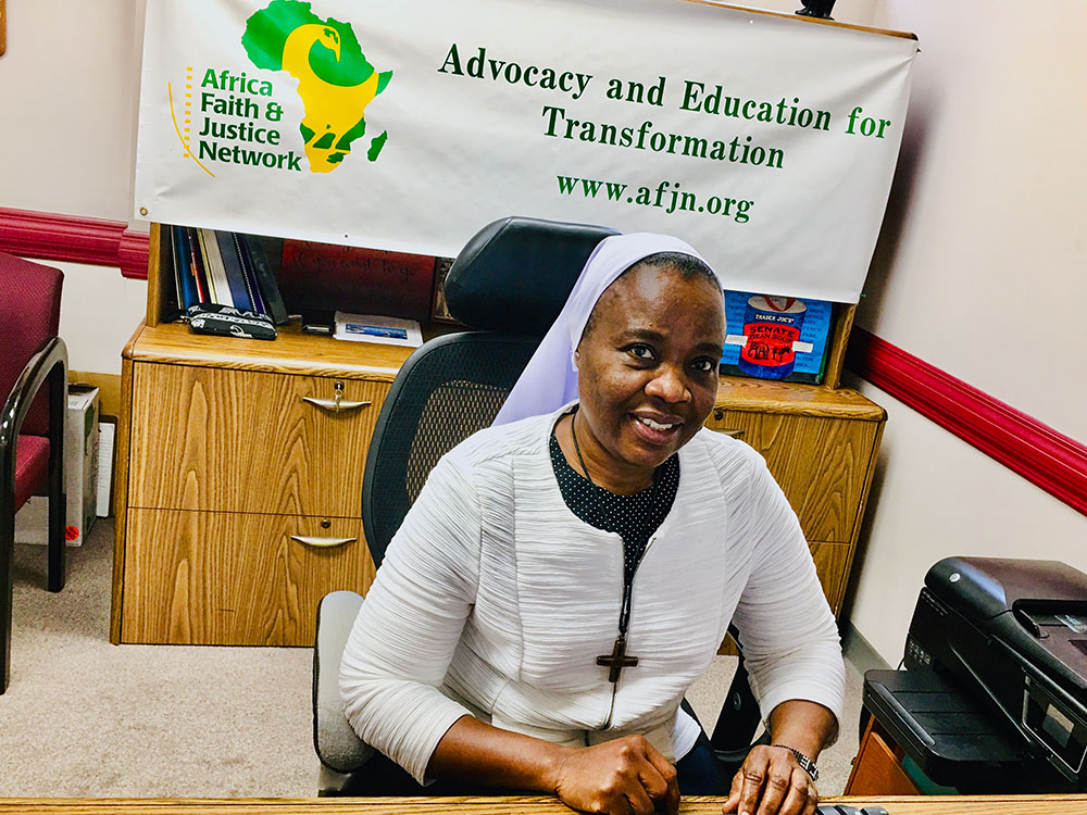 Notre Dame de Namur Sr. Eucharia Madueke poses in her office in Washington, D.C. Madueke is the coordinator of the Africa Faith and Justice Network's Women Empowerment Project. In her role, she works with sisters across Nigeria, training and mobilizing them to raise awareness about gender-based violence, human trafficking and harmful cultural practices. (Courtesy of Eucharia Madueke)