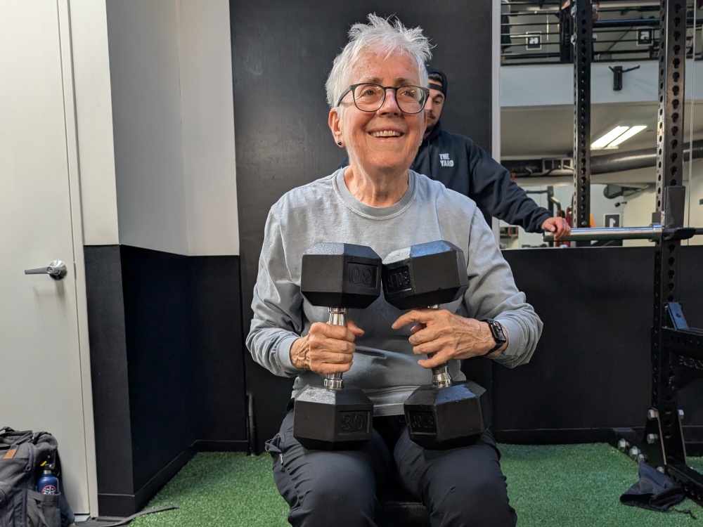 Sr. Pat Farrell training Sr. Pat Farrell holding two 30-pound dumbbells while training with trainer and spotter Jake Levine at The Yard gym. (Erin Edwards)