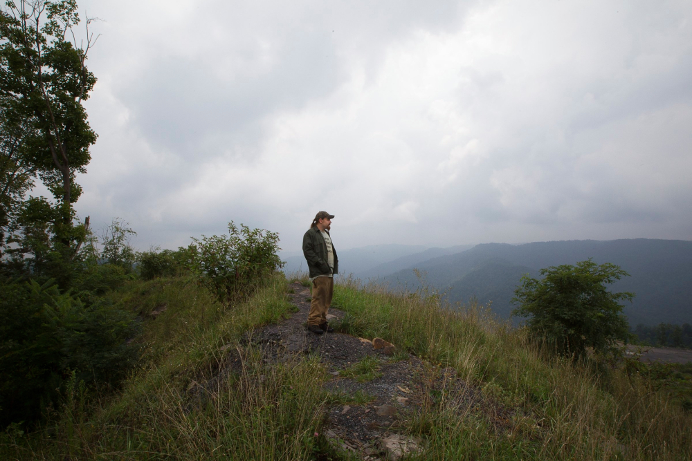 A man in Naoma, W. Va., is seen near the a mountaintop removal coal mine on Kayford Mountain Aug. 19, 2014 A man in Naoma, W. Va., is seen near the a mountaintop removal coal mine on Kayford Mountain Aug. 19, 2014. The Catholic Committee of Appalachia, a membership-based organization, has served Appalachia, the poor and creation since 1970. (CNS / Tyler Orsburn)