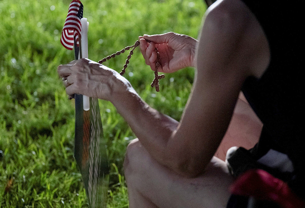 A woman holds a rosary as Catholics from across the Phoenix area gather at Desert Horizon Park in Scottsdale, Arizona, Sept.10, 2025, to pray for conservative activist Charlie Kirk, who was shot and killed that day during a Turning Point USA event at Utah Valley University in Orem. Kirk was co-founder of Turning Point USA. (OSV News/Reuters/Caitlin O'Hara)