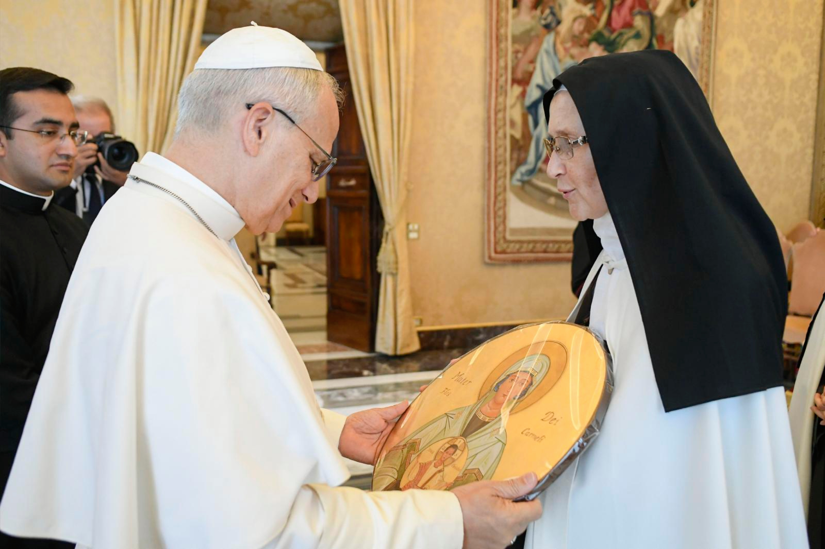 Pope Leo XIV receives a gift from a member of the Discalced Carmelite Sisters of the Holy Land