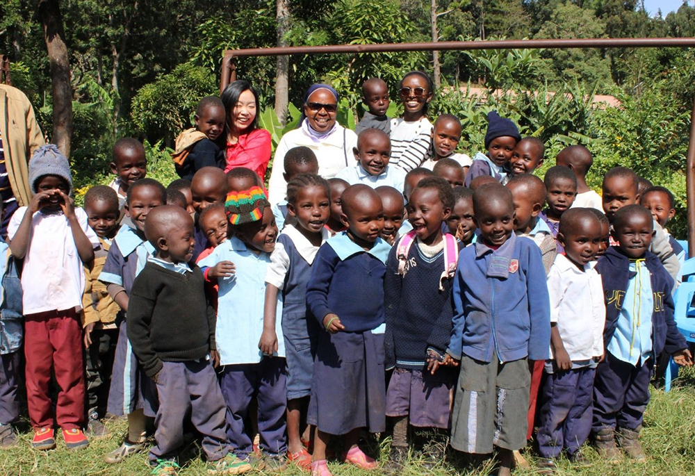 Sr. Lucy Kanjira, center, poses with her day care students during the International Day of the African Child 2025. Kanjira is project coordinator for the Congregation of Our Lady of Charity of the Good Shepherd Eastern Central Africa Province. (Courtesy of Doreen Mukami)
