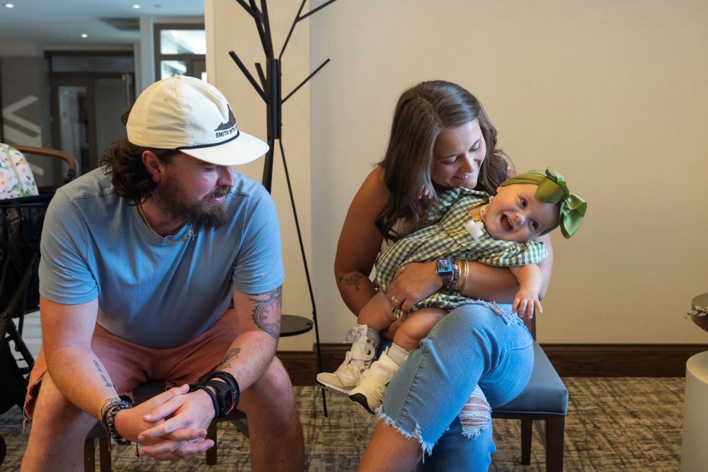 Bryan and Taylor McClain sit with their daughter, Violette. Bryan and Taylor McClain sit with their daughter, Violette.