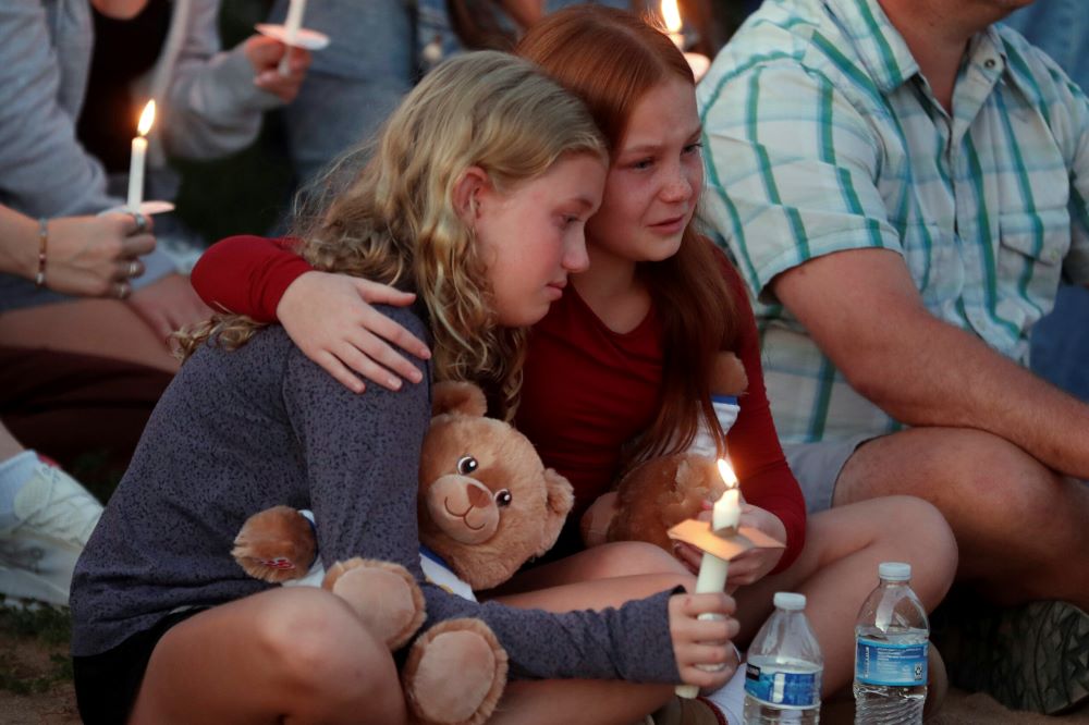 People gather at a vigil at Lynnhurst Park after a fatal shooting at the Annunciation Catholic School, Aug. 27 in Minneapolis. (AP Photo/Bruce Kluckhohn) People gather at a vigil at Lynnhurst Park after a fatal shooting at the Annunciation Catholic School, Aug. 27 in Minneapolis. (AP Photo/Bruce Kluckhohn)