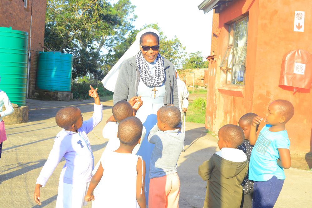 A sister from the Daughters of St. Francis of Assisi interacts with children at an outreach center in Durban, South Africa. 