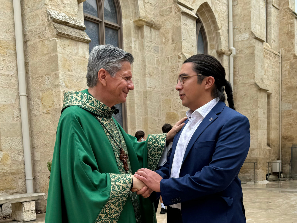Antonio Frietze, who helped lead an effort for the Archdiocese of San Antonio to join the Laudato Si Platform, shakes hands with Archbishop Gustavo Garcia-Siller during a mass celebrating making a climate action commitment. (Courtesy of Catholic Climate Covenant) Antonio Frietze, right, who helped lead an effort for the Archdiocese of San Antonio to join the Laudato Si Platform, shakes hands with Archbishop Gustavo Garcia-Siller, left, during a mass celebrating making a climate action commitment. (Courtesy of Catholic Climate Covenant)