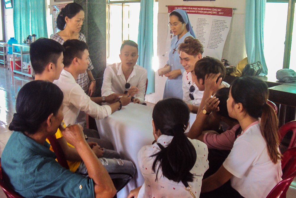 Sr. Marie Magdalene Duong Thi Nguyet of the Daughters of Mary of the Immaculate Conception listens to high-risk individuals share their struggles at Kim Long Charity Clinic in Hue, Vietnam, on Oct. 11, 2025. (GSR photo)