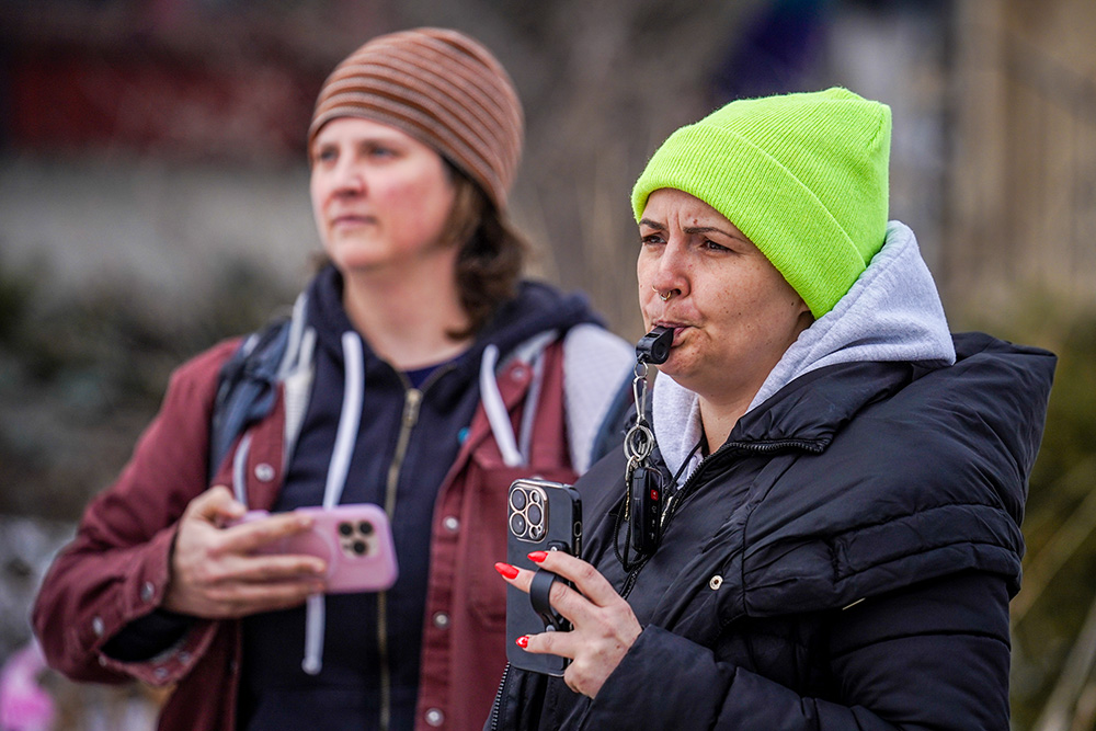 Observers blow their whistles while federal agents conduct immigration enforcement operations on Feb. 5, 2026, in Minneapolis. (AP/Ryan Murphy)