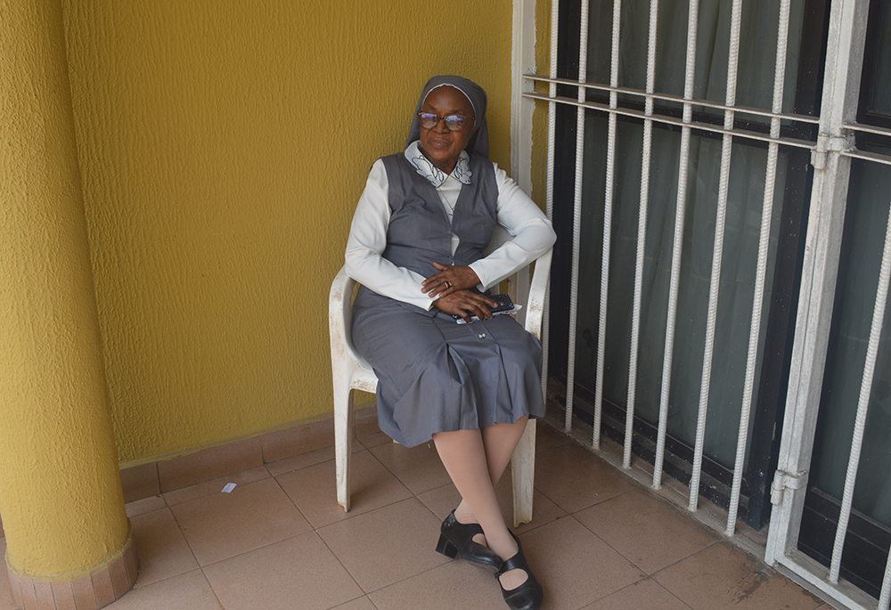 Sr. Anthonia Ibeh, a member of the Medical Missionaries of Mary Ibeh who leads the catechism class every Wednesday for two hours to inmates, poses in front of the sisters' convent in Benin City, Nigeria. (Valentine Benjamin)