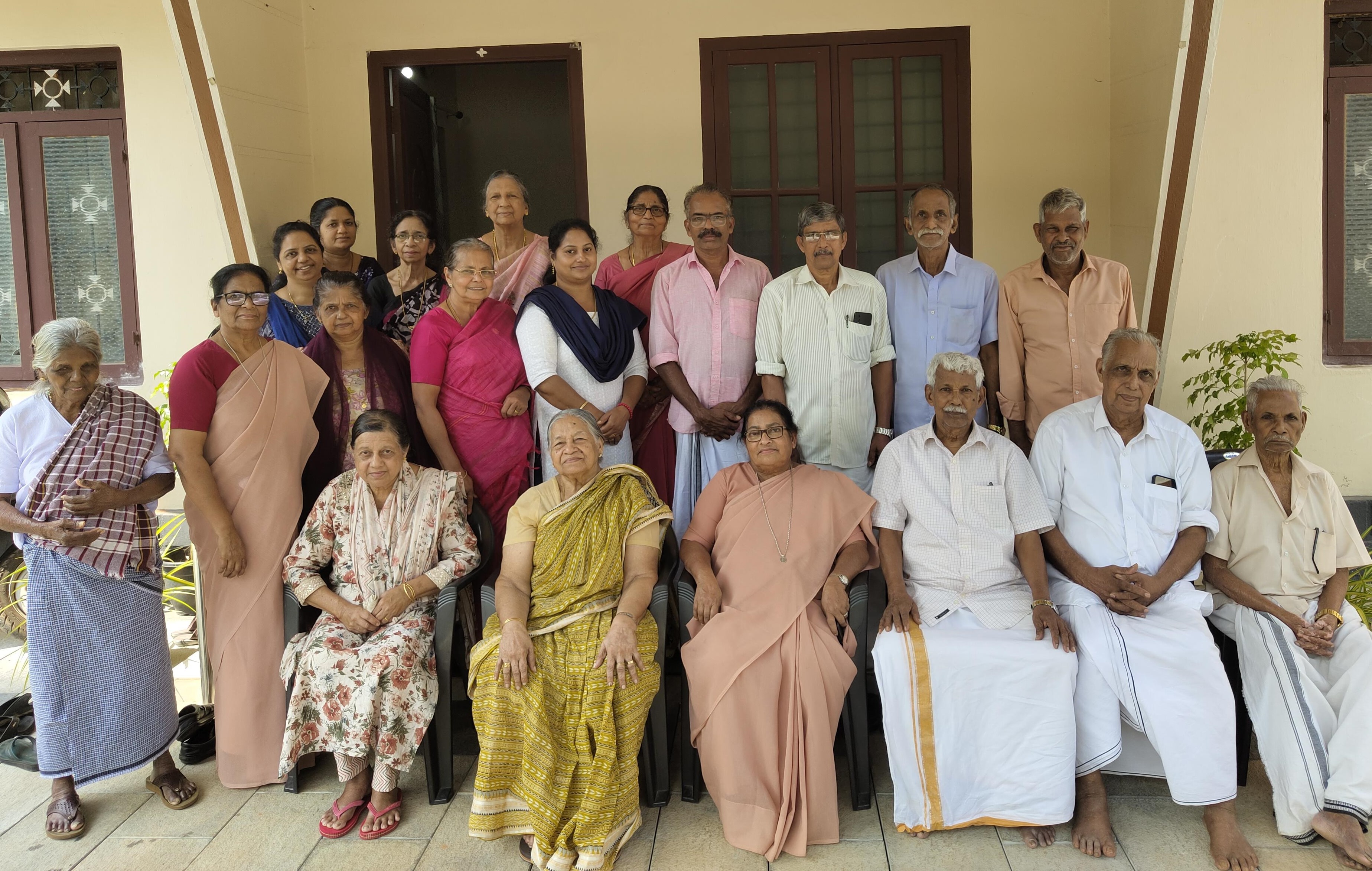 The members of Asa Nilayam Pakal Veedu (Abode of Hope Day Home), a center for the elderly, pose for a photograph with Srs. Anice Vattukulam and Nisha Chemmanam in front of the Nazareth convent at Kallanode, a village in Kozhikode district, Kerala, southwestern India. (George Kommattam)