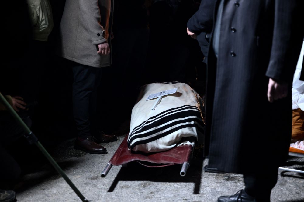 A coffin holding the body of Yaakov Biton is seen during his funeral and the funeral of his two sisters, Sara and Avigail, who were killed in an Iranian missile strike March 1, amid the U.S.-Israel war with Iran, in a cemetery in Jerusalem, March 2. (OSV News/Reuters/Jamal Awad)