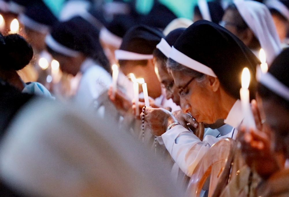 Catholic nuns with lighted candles pray at the adoration of the Blessed Sacrament in support of religious life at the Pastoral Centre of Dwaraka parish in the Mananthavady Diocese in Kerala, southern India. (Saji Thomas) Catholic nuns with lighted candles pray at the adoration of the Blessed Sacrament in support of religious life at the Pastoral Centre of Dwaraka parish in the Mananthavady Diocese in Kerala, southern India. (Saji Thomas)