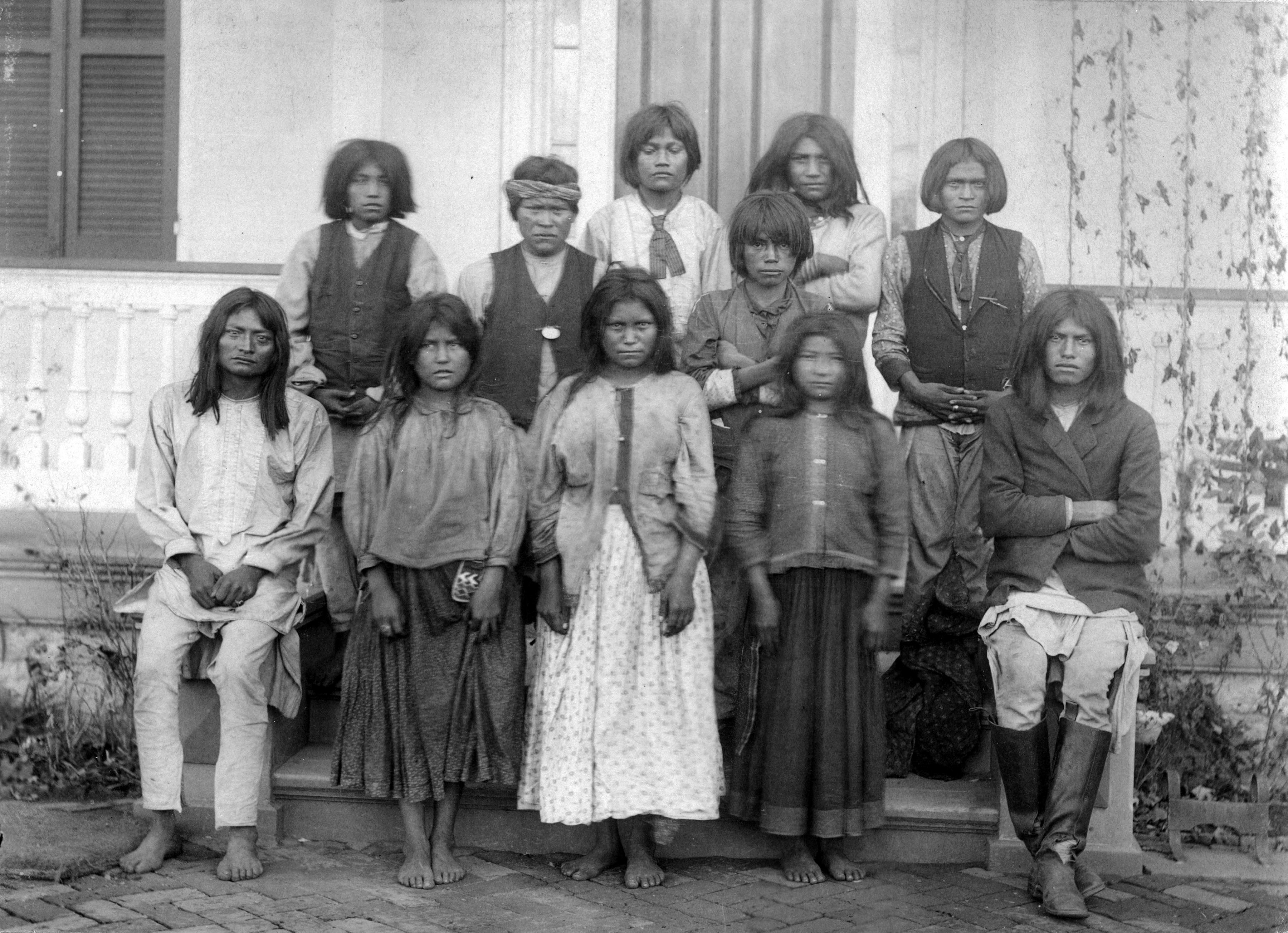 Native American (Chiricahua Apache) boys and girls pose outdoors at the Carlisle Indian Industrial School in Carlisle, Pennsylvania, after their arrival from Fort Marion, Florida, in November 1886. Photo by J. N. Choate/Creative Commons Native American (Chiricahua Apache) boys and girls pose outdoors at the Carlisle Indian Industrial School in Carlisle, Pennsylvania, after their arrival from Fort Marion, Florida, in November 1886. Photo by J. N. Choate/Creative Commons