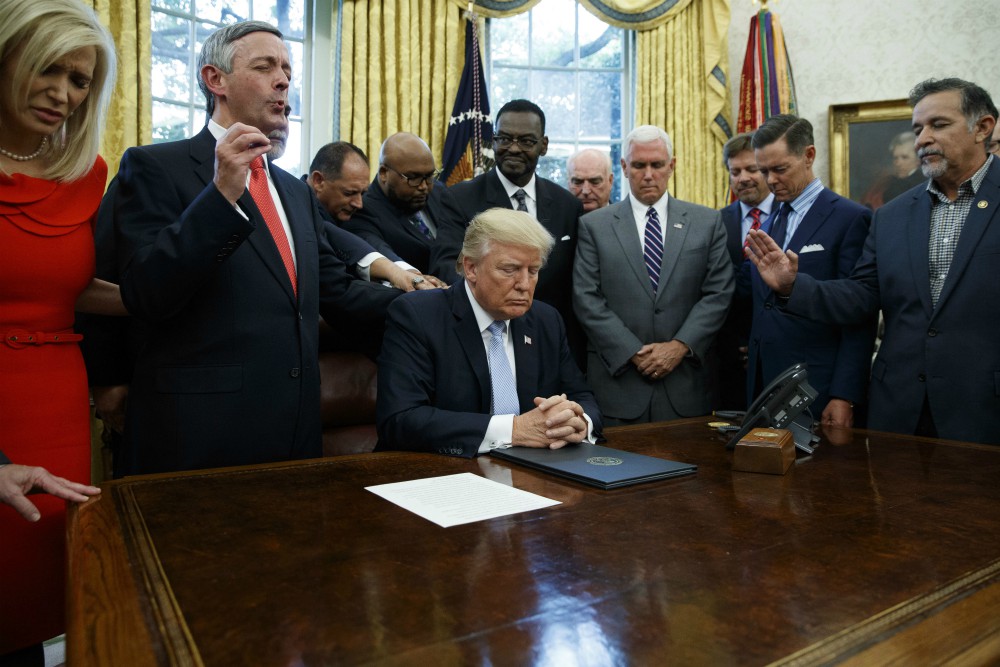On Sept. 1, 2017, religious leaders pray with President Donald Trump in the Oval Office of the White House in Washington after he signed a proclamation for a National Day of Prayer to occur on Sunday, Sept. 3, 2017. (AP Photo/Evan Vucci) On Sept. 1, 2017, religious leaders pray with President Donald Trump in the Oval Office of the White House in Washington after he signed a proclamation for a National Day of Prayer to occur on Sunday, Sept. 3, 2017. (AP Photo/Evan Vucci)