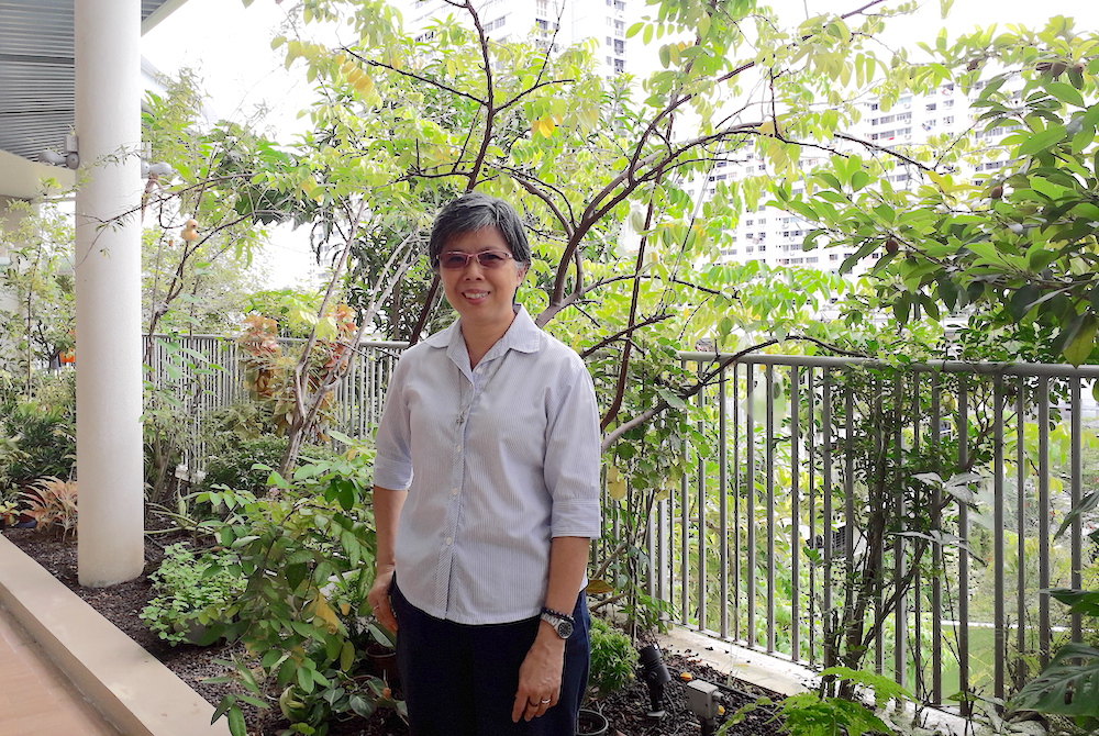 Good Shepherd Sr. Agnes-Claire Koh poses in front of the Good Shepherd Sisters' main convent; public housing can be seen in the background. (Provided photo) Good Shepherd Sr. Agnes-Claire Koh poses in front of the Good Shepherd Sisters' main convent; public housing can be seen in the background. (Provided photo)