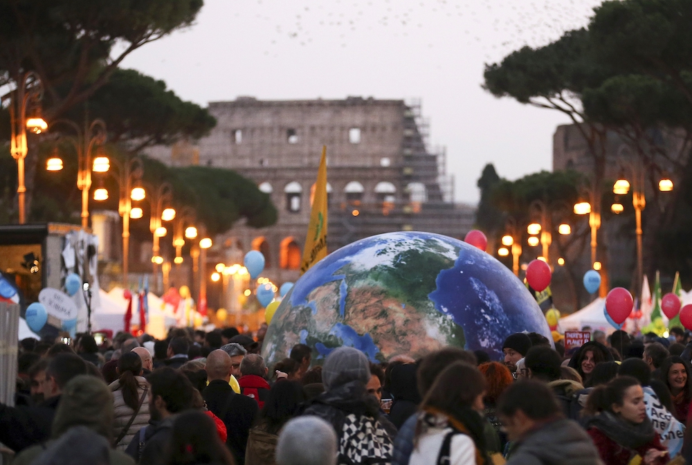 Protesters carry a globe-shaped balloon in front of Rome's Colosseum during a Nov. 29, 2015, rally, the day before the start of the U.N. climate change conference in Paris. (CNS/Reuters/Alessandro Bianchi) Protesters carry a globe-shaped balloon in front of Rome's Colosseum during a Nov. 29, 2015, rally, the day before the start of the U.N. climate change conference in Paris. (CNS/Reuters/Alessandro Bianchi)