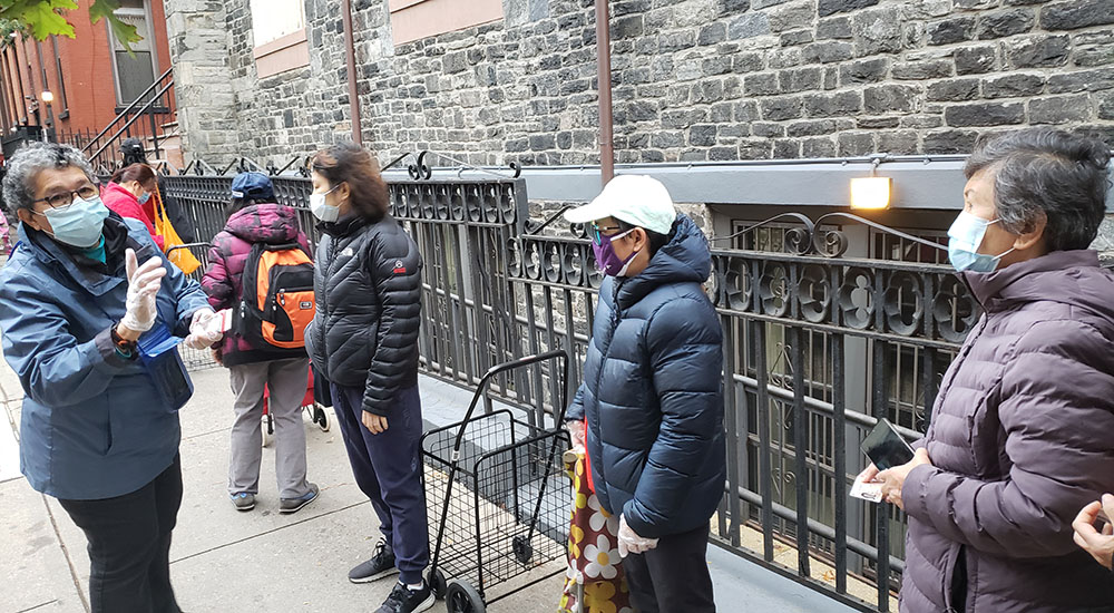 Sr. Yolanda Flores, left, talks to people in line for Cabrini Immigrant Services' weekly food pantry in Manhattan's Lower East Side on Oct. 27. (GSR photo/Chris Herlinger) Sr. Yolanda Flores, left, talks to people in line for Cabrini Immigrant Services' weekly food pantry in Manhattan's Lower East Side on Oct. 27. (GSR photo/Chris Herlinger)