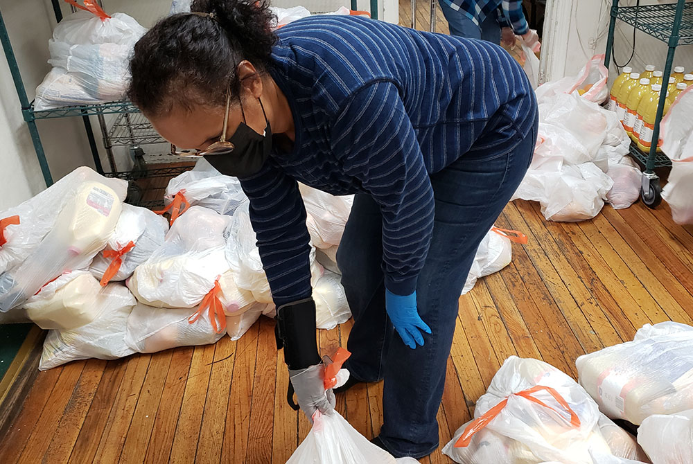 Volunteer Heather Lee organizes food packages to be distributed Oct. 27 at Cabrini Immigrant Services, located in Lower East Side, Manhattan, New York City. (GSR photo/Chris Herlinger) Volunteer Heather Lee organizes food packages to be distributed Oct. 27 at Cabrini Immigrant Services, located in Lower East Side, Manhattan, New York City. (GSR photo/Chris Herlinger)