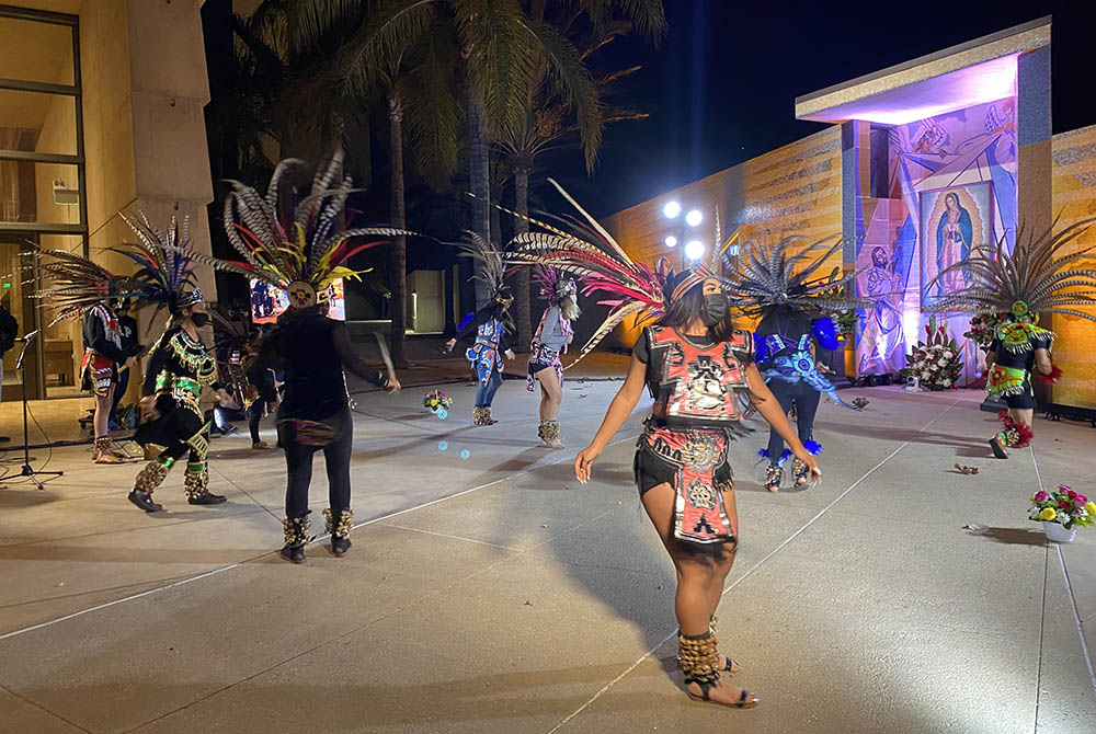 Aztec dancers wearing face masks honor Our Lady of Guadalupe in front of a shrine designed by artist Lalo Garcia in the courtyard of the Cathedral of Our Lady of the Angels in downtown Los Angeles. The performance, part of a Dec. 9 press event, was taped Aztec dancers wearing face masks honor Our Lady of Guadalupe in front of a shrine designed by artist Lalo Garcia in the courtyard of the Cathedral of Our Lady of the Angels in downtown Los Angeles. The performance, part of a Dec. 9 press event, was taped