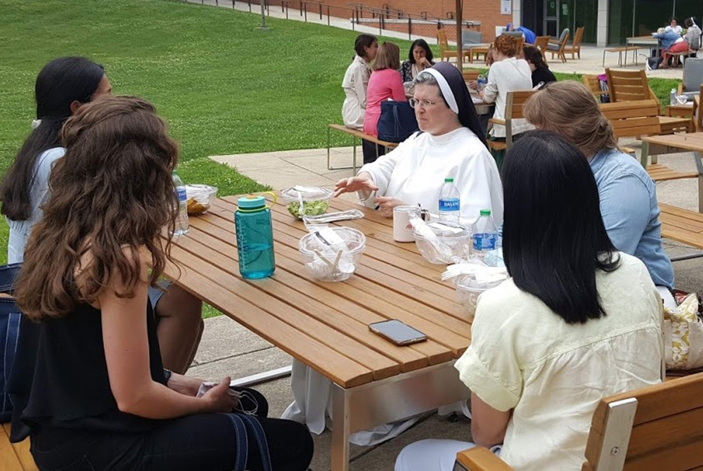 Sr. Mary Madeline Todd, center, a Dominican Sister of St. Cecilia and assistant professor of theology at Aquinas College in Nashville, talks with her mentoring group during an afternoon break at the 2021 Given forum. Todd gave a keynote speech June 12 in Sr. Mary Madeline Todd, center, a Dominican Sister of St. Cecilia and assistant professor of theology at Aquinas College in Nashville, talks with her mentoring group during an afternoon break at the 2021 Given forum. Todd gave a keynote speech June 12 in