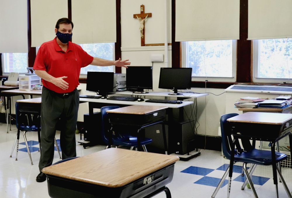 Principal Robert Chevrier shows off a socially distanced sixth-grade classroom at St. Joseph School in Medford, Massachusetts, July 28. Soon the desks will all have plastic dividers as well. (Alexander Thompson) Principal Robert Chevrier shows off a socially distanced sixth-grade classroom at St. Joseph School in Medford, Massachusetts, July 28. Soon the desks will all have plastic dividers as well. (Alexander Thompson)