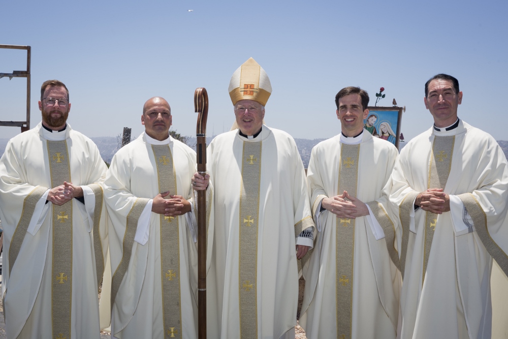 Bishop Robert McElroy stands with, from left, newly ordained Jesuit Frs. J.T. Tanner, Elías Puentes, Alejandro Báez and Thomas Flowers. (Jon Rou) Bishop Robert McElroy stands with, from left, newly ordained Jesuit Frs. J.T. Tanner, Elías Puentes, Alejandro Báez and Thomas Flowers. (Jon Rou)