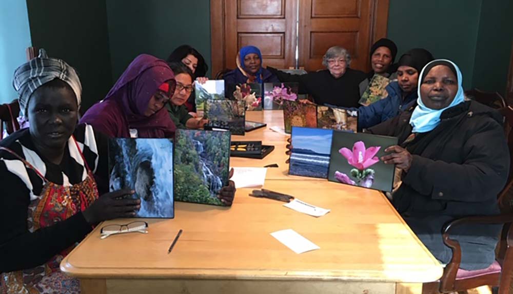 Some of the single moms gather at Mary's House to frame nature photos donated by a photographer and friend of the program. (Provided photo) Some of the single moms gather at Mary's House to frame nature photos donated by a photographer and friend of the program. (Provided photo)