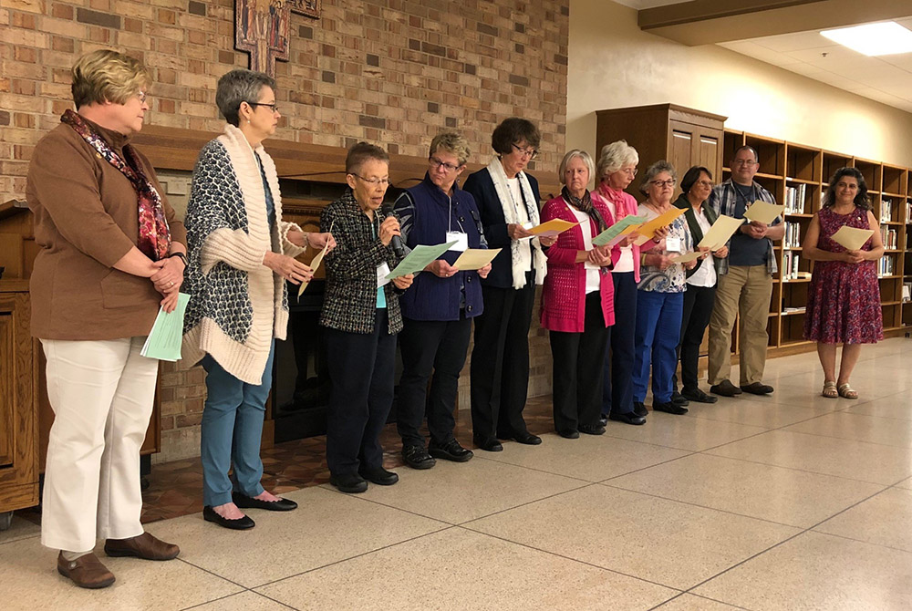 Eleven cojourners of the Sisters of St. Francis of Rochester, Minnesota, renew their covenant in October 2019 in front of an audience of other cojourners, family members and sisters. (Courtesy of the Rochester Franciscans) Eleven cojourners of the Sisters of St. Francis of Rochester, Minnesota, renew their covenant in October 2019 in front of an audience of other cojourners, family members and sisters. (Courtesy of the Rochester Franciscans)