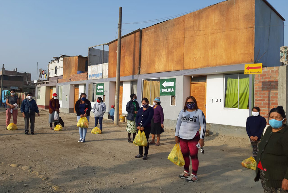 Women distribute food in Cajamarquilla outside Lima, Peru, buying large quantities at affordable prices to sell cheaply to the community while making a small profit for themselves, said Comboni Missionary Sr. Socorro Palomino, who helped organize the wome Women distribute food in Cajamarquilla outside Lima, Peru, buying large quantities at affordable prices to sell cheaply to the community while making a small profit for themselves, said Sr. Socorro Palomino. (Courtesy of Socorro Palomino)