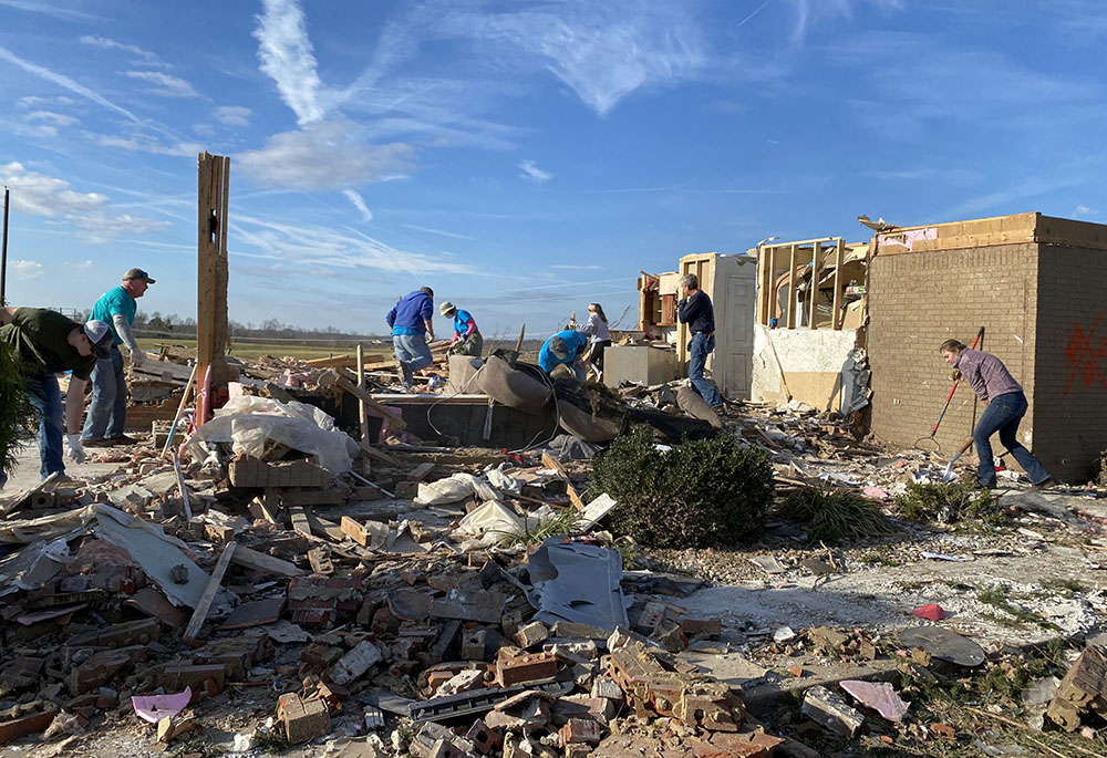 Volunteers with the Sisters of Charity of Nazareth sort through and clear debris from a home severely damaged by tornadoes in Campbellsville, Kentucky, accompanied by the surviving family and friends. (Courtesy of Ellen Sprigg) Volunteers with the Sisters of Charity of Nazareth sort through and clear debris from a home severely damaged by tornadoes in Campbellsville, Kentucky, accompanied by the surviving family and friends. (Courtesy of Ellen Sprigg)