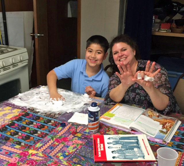 A tutor and a student work together at a migrant center. A tutor and a student work together at a migrant center.