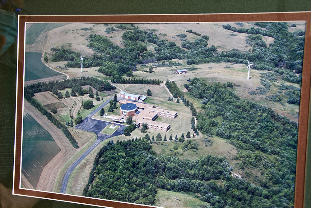 The Sacred Heart Benedictine Monastery in Dickinson, North Dakota, has a framed photo of the community's former convent, which had the first commercial wind turbines in the state. (GSR photo/Dan Stockman) The Sacred Heart Benedictine Monastery in Dickinson, North Dakota, has a framed photo of the community's former convent, which had the first commercial wind turbines in the state. (GSR photo/Dan Stockman)