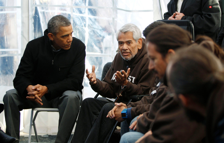 U.S. President Barack Obama listens to hunger striker Eliseo Medina during a Nov. 29, 2013 visit with immigration reform advocates in their tent on the National Mall in Washington. (CNS/Reuters/Jason Reed)