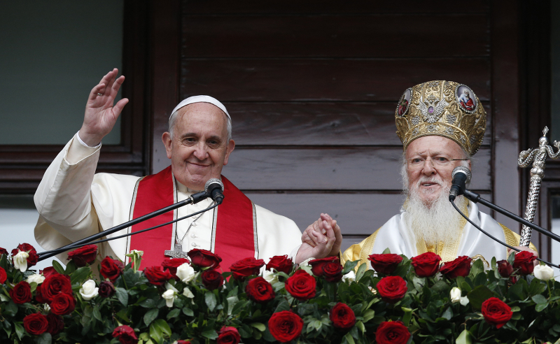 Pope Francis and Ecumenical Patriarch Bartholomew of Constantinople greet a small crowd after delivering a blessing in Istanbul Nov. 30. (CNS photo/Paul Haring)