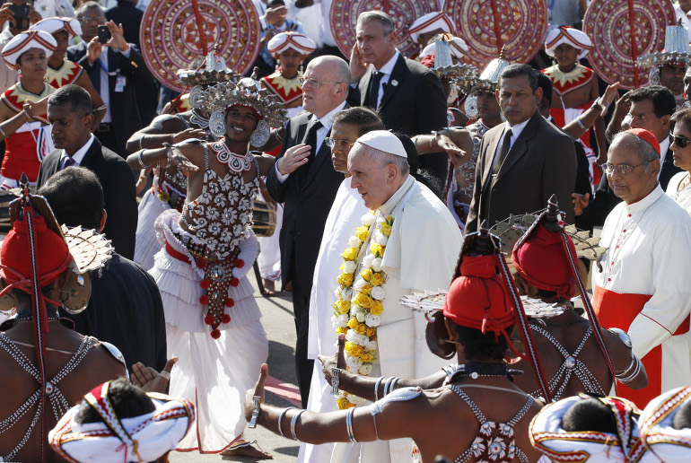 To the sounds of traditional dancers and drummers, Pope Francis arrives at the international airport in Colombo, Sri Lanka, Jan. 13. (CNS photo/Paul Haring)