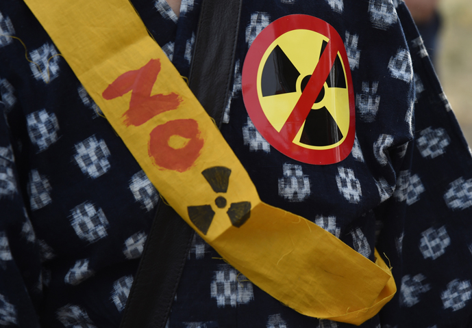 A protestor wears an anti-nuclear symbol and a slogan during an Aug. 6 rally outside the Lawrence Livermore National Laboratory in Livermore, Calif. (CNS/John Mabanglo, EPA)