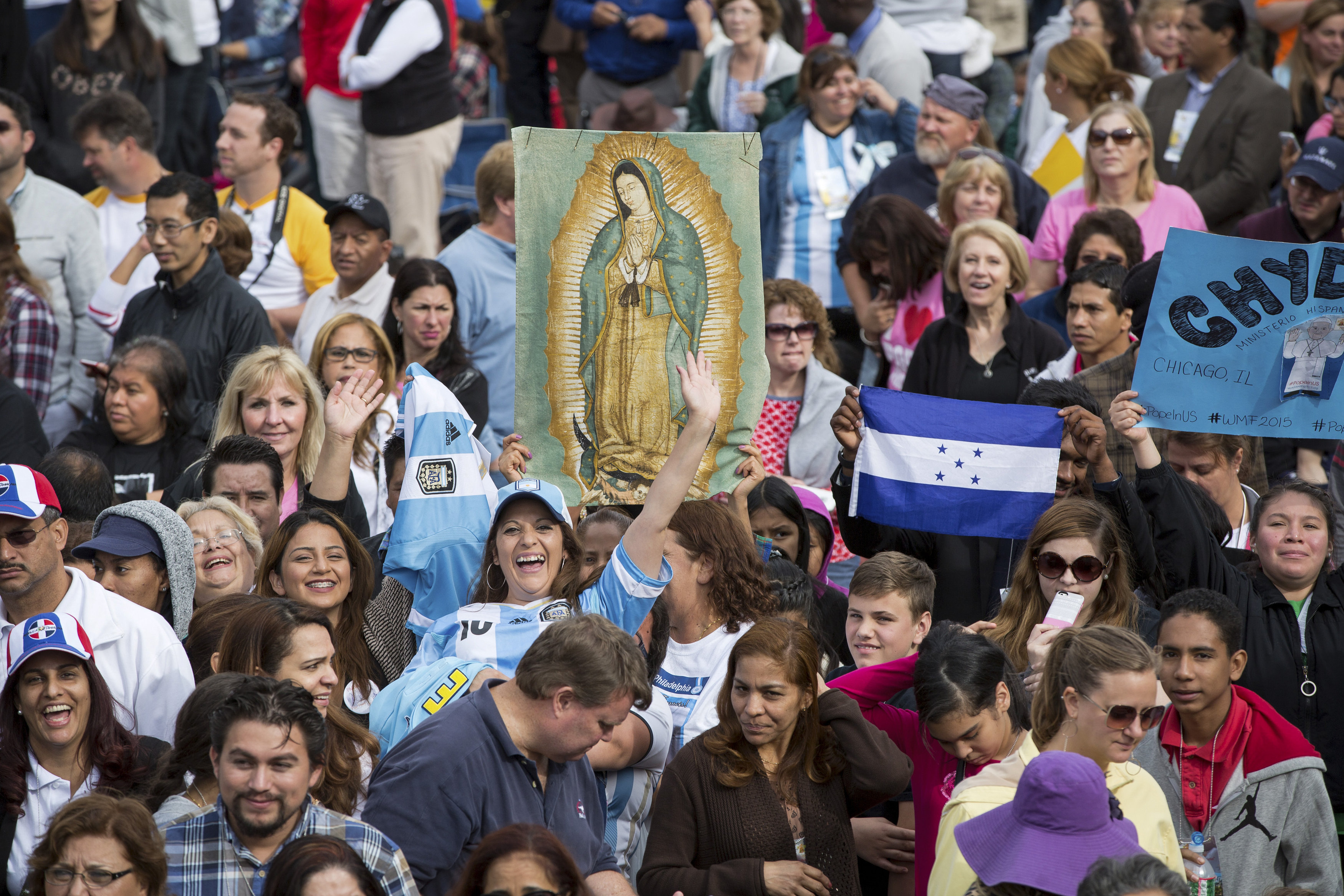 An image of Our Lady of Guadalupe is held up as crowds gather at Independence Mall, where Pope Francis will talk about immigration and religious freedom to an estimated crowd of 50,000, in Philadelphia Sept. 26. (CNS/Lisa Johnston)