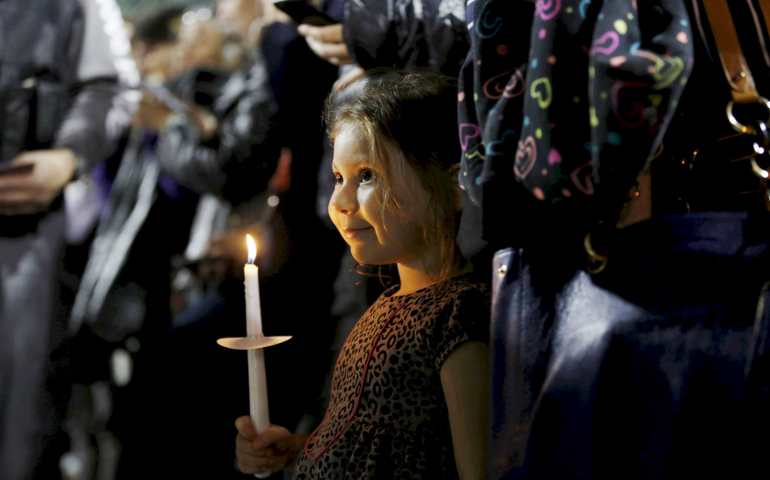A girl attends a candlelight vigil in San Bernardino, Calif., Dec. 3 for the victims of a mass shooting the previous day at the Inland Regional Center. (CNS/Reuters/Mario Anzuoni)