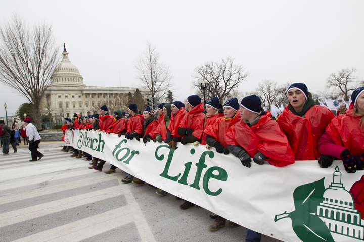 Young people walk with a banner past the U.S. Capitol in 2012 during the annual March for Life in Washington. (CNS/Bob Roller)