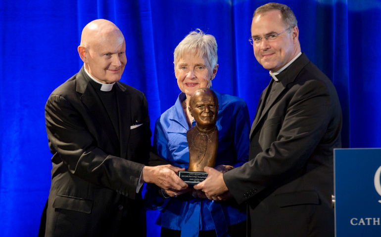Fr. Arne Panula, an Opus Dei priest who is director of the Catholic Information Center in Washington, presents the center's fifth-annual St. John Paul II Award for the New Evangelization honoring the late U.S. Supreme Court Justice Antonin Scalia. (CNS/Catholic Standard/Jaclyn Lippelmann)