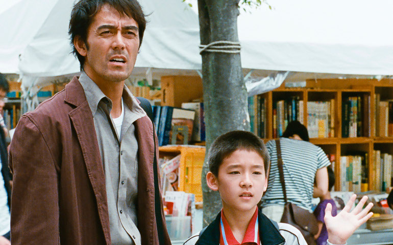 Hiroshi Abe plays Ryota Shinoda, left, the father of Shingo Shiraishi, played by Taiyo Yoshizawa, in “After the Storm.” (Film Movement)