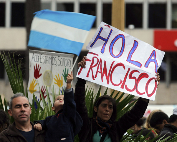 A woman holds a sign that reads "Hello Francis" as people gather to watch a broadcast of the inaugural Mass of Pope Francis on Tuesday near the Metropolitan Cathedral in Buenos Aires, Argentina. (CNS/Reuters/Marcos Brindicci)