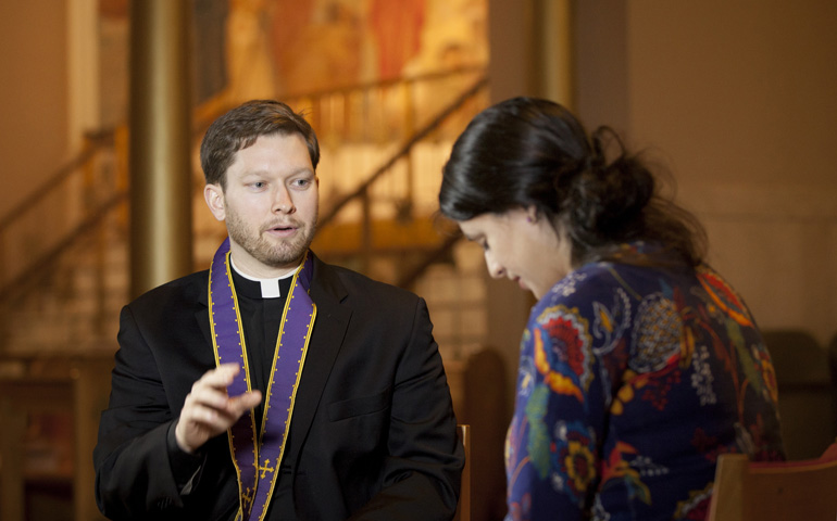 Fr. Kevin Regan of the Washington archdiocese demonstrates the granting of absolution that occurs during the sacrament of reconciliation. (CNS/Nancy Phelan Wiechec)